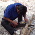 Our carpenter, Mr No, setting a saw with a claw hammer