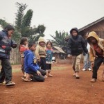 Children playing while Siobanh Collie  looks on