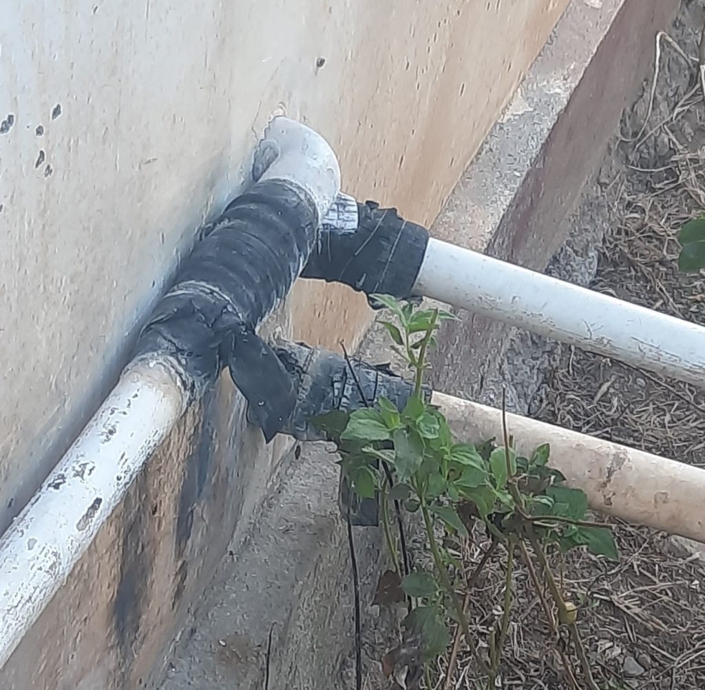 A typical pipe join/repair using rubber from tyre innertubes(it does not work well!)