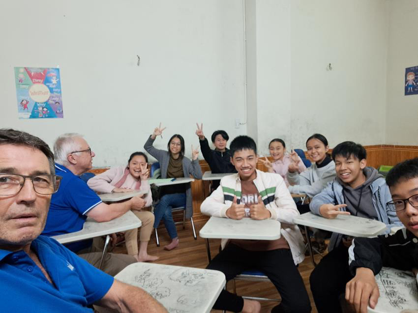 Dr Denis and Brian (closer) with a very active English class. The young girl (third person from the right andage 14) asked us on the street if we would come to their night class and talk to them in English. We all had quite a bit of fun, as you can see!