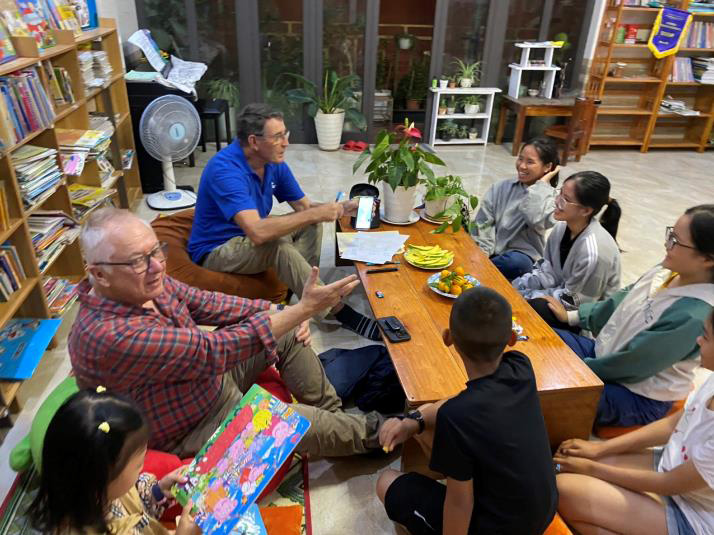 Dr Denis (closer to camera) and Brian having fun speaking English with a small evening class – talking about Australian animals which they could think the names of