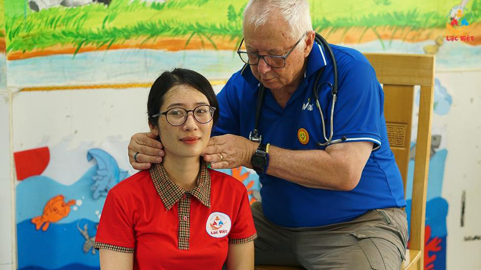 Dr Denis checking the teacher’s lymph glands to ensure no swelling. He then went on to check the children’s necks, as well as their heart and lungs