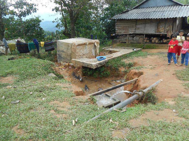 An existing issue: Lack of maintenance on the small offshoot pipe leading off the 100mm main supply pipe, with water continually flowing,has caused all that erosion, such that the concrete water tank has fallen into the eroded trench. What a waste of money, for what could have been fixed so easily and inexpensively! Why? No community involvement in the original construction, no maintenance training provided to the villagers, and no government maintenance funding! Therefore, no “ownership” by the village = non-sustainability. MiVAC reverses all this!